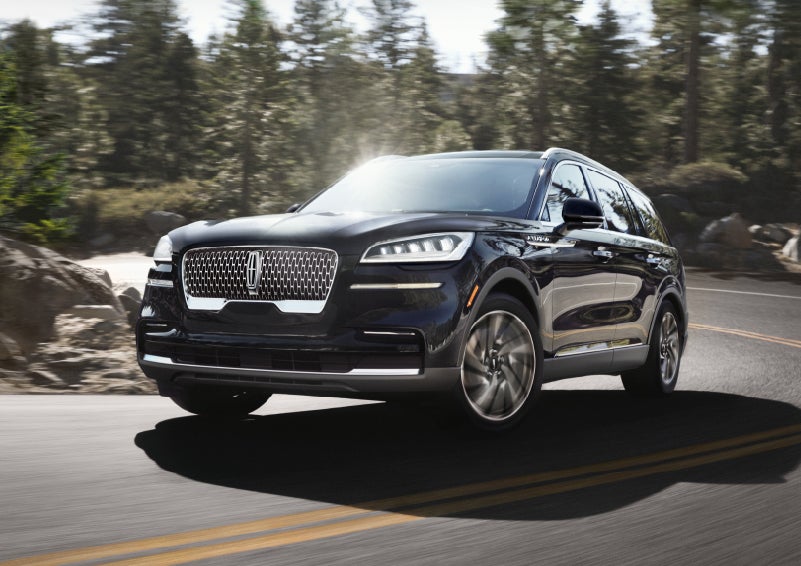 A Lincoln Aviator® SUV is being driven on a winding mountain road | Lincoln Demo 5 in Derwood MD