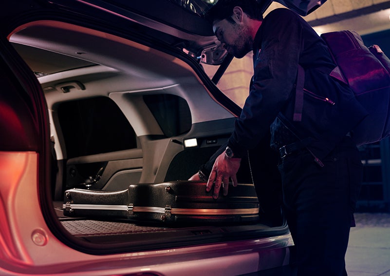 A man is shown loading cargo into the rear of a 2024 Lincoln Corsair® SUV with the second-row seats folded flat. | Lincoln Demo 5 in Derwood MD