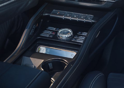 A smartphone is shown charging in the wireless charging pad. | Lincoln Demo 5 in Derwood MD